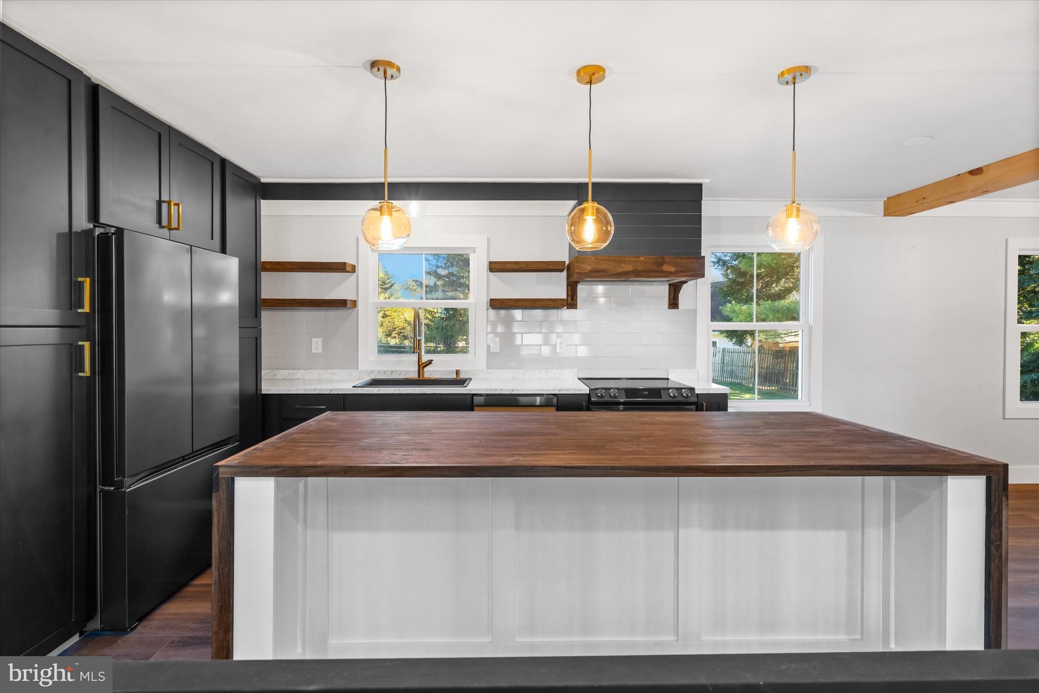 108 Evanson Road Hockessin, DE 19707 - Photo 10 of 49 a kitchen with kitchen island a counter top space appliances and a window