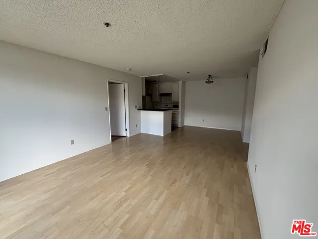 a view of a kitchen with wooden floor and a sink