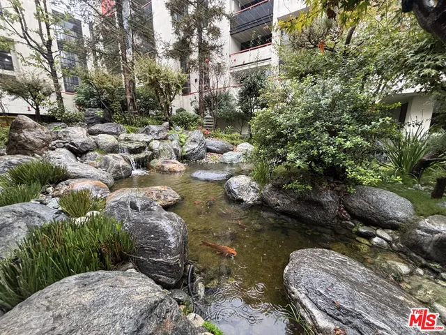a backyard of a house with a yard and outdoor seating