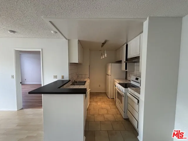 a kitchen with a sink and a stove
