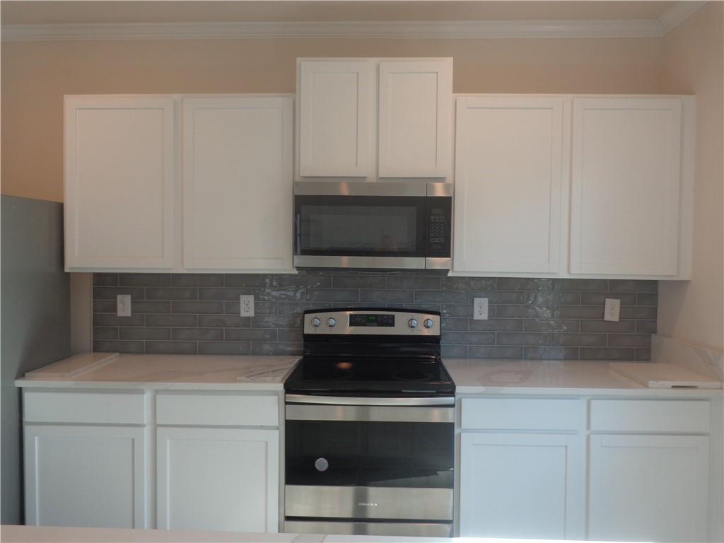 132 Russell Road Pendergrass, GA 30567 - Photo 16 of 50 a kitchen with a stove and a microwave