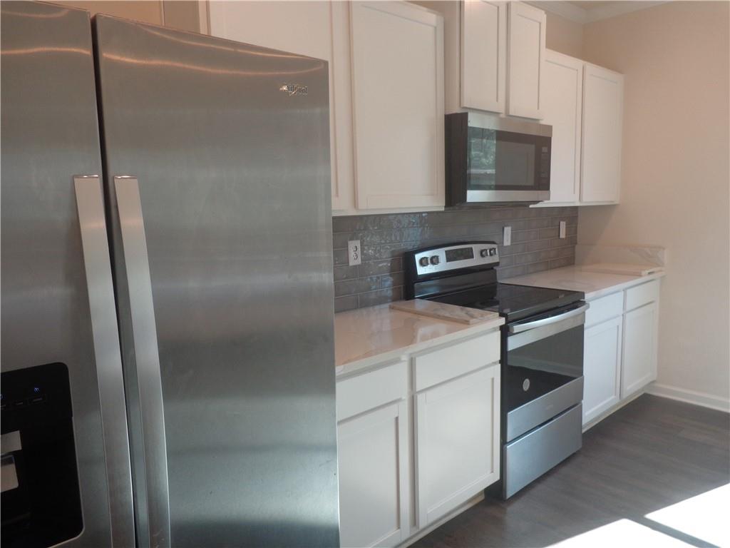 132 Russell Road Pendergrass, GA 30567 - Photo 17 of 50 a kitchen with a refrigerator sink and microwave