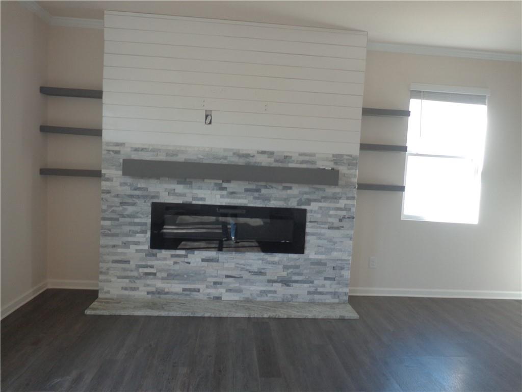 132 Russell Road Pendergrass, GA 30567 - Photo 19 of 50 a living room with a fireplace and a wooden floor