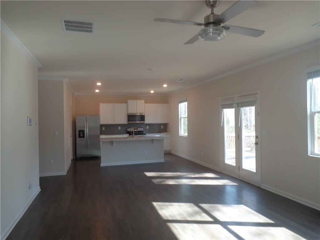 132 Russell Road Pendergrass, GA 30567 - Photo 21 of 50 a kitchen with stainless steel appliances kitchen island granite countertop a refrigerator a sink and a stove