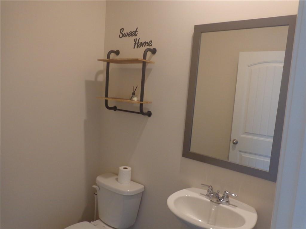 132 Russell Road Pendergrass, GA 30567 - Photo 22 of 50 a bathroom with a toilet sink and mirror