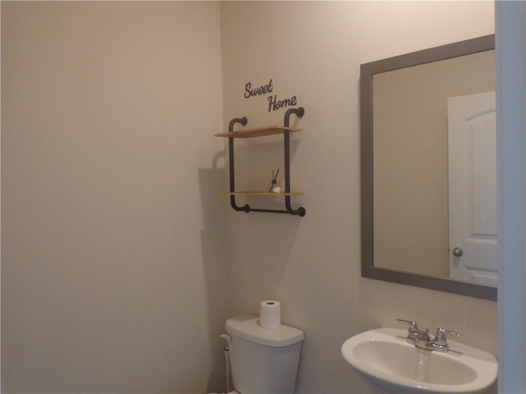 132 Russell Road Pendergrass, GA 30567 - Photo 23 of 50 a bathroom with a toilet sink and mirror