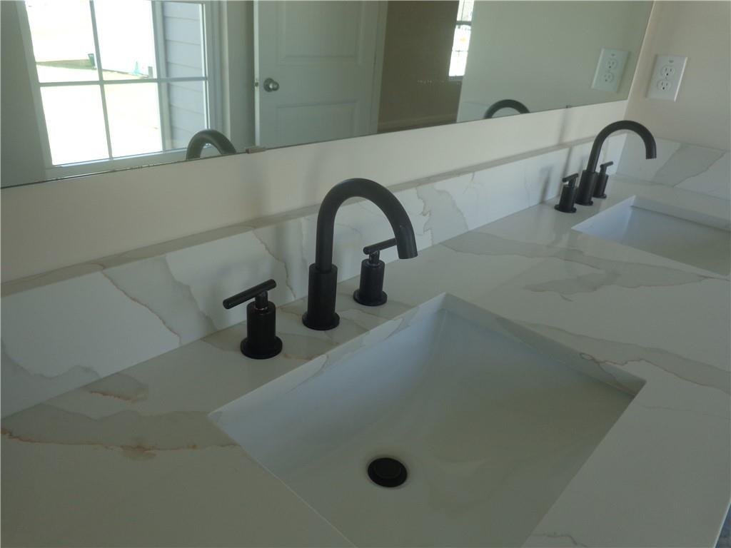 132 Russell Road Pendergrass, GA 30567 - Photo 26 of 50 a close view of a sink a faucet a window and a door in the bathroom