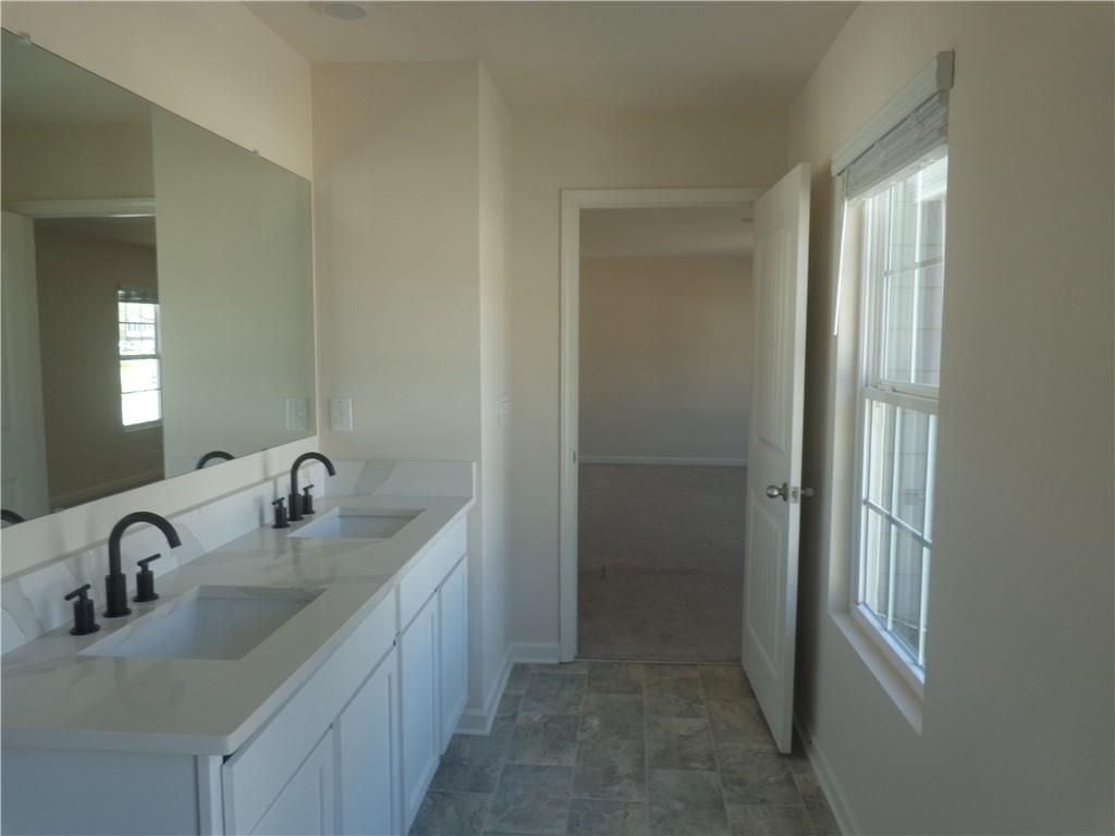 132 Russell Road Pendergrass, GA 30567 - Photo 28 of 50 a bathroom with a sink and a mirror