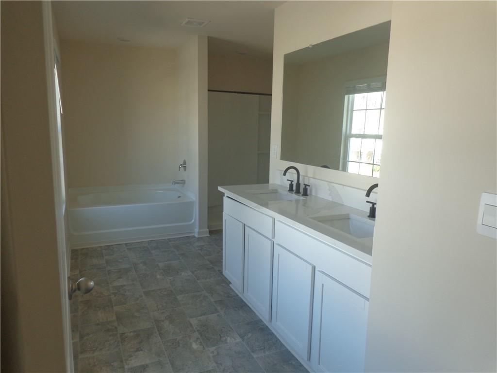 132 Russell Road Pendergrass, GA 30567 - Photo 29 of 50 a bathroom with a shower sink and mirror