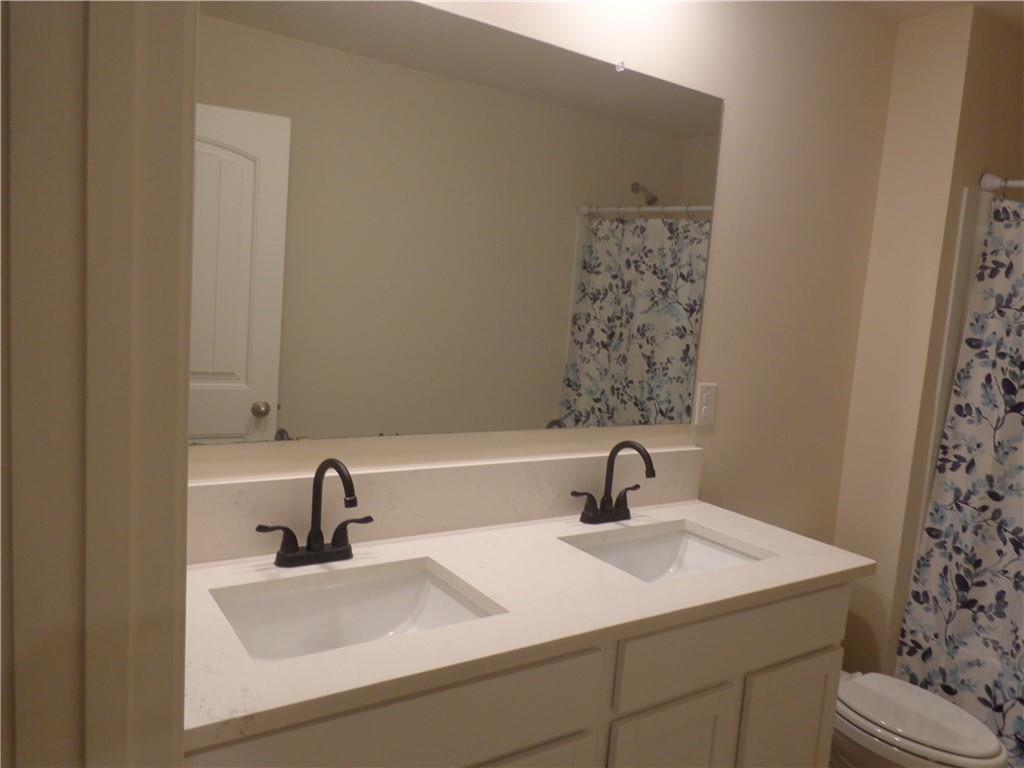 132 Russell Road Pendergrass, GA 30567 - Photo 30 of 50 a bathroom with a sink and a mirror