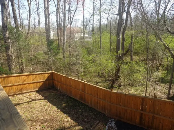 a view of balcony with wooden fence