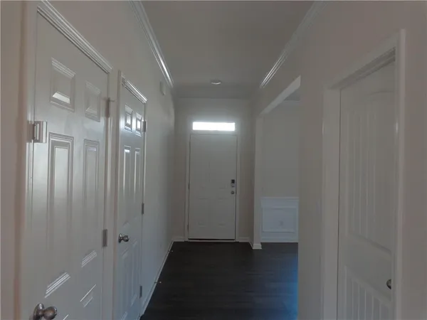 a view of a hallway with wooden floor