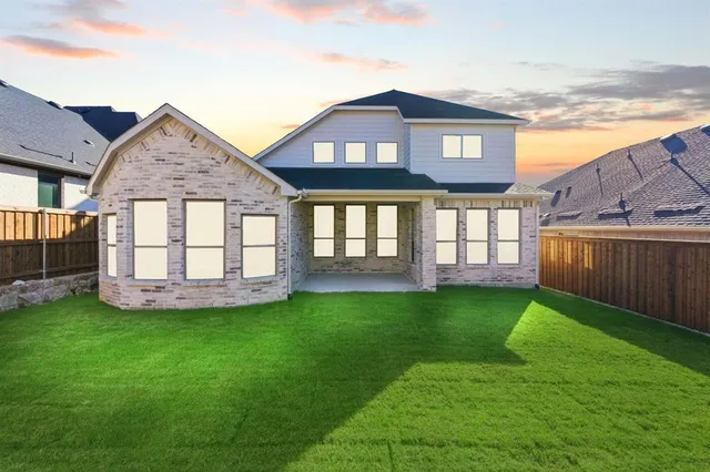 a view of a house with a yard and sitting area
