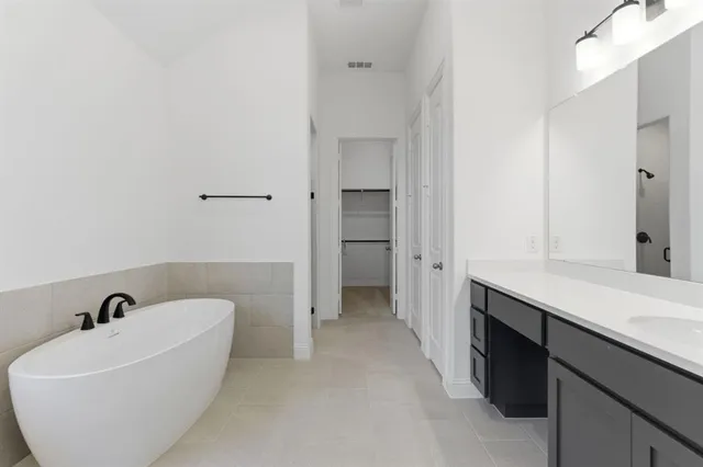a bathroom with a bathtub and sink