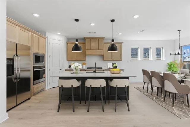 a large kitchen with a table and chairs