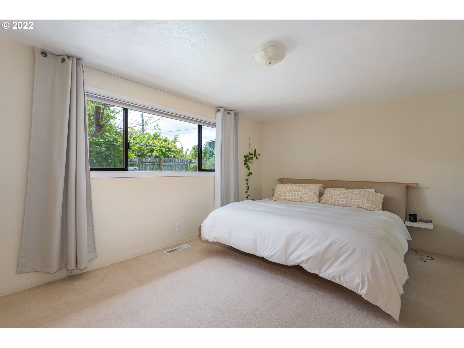 2390 Frontier Drive Eugene, OR 97401 - Photo 13 of 32 a bedroom with a large bed and a large window
