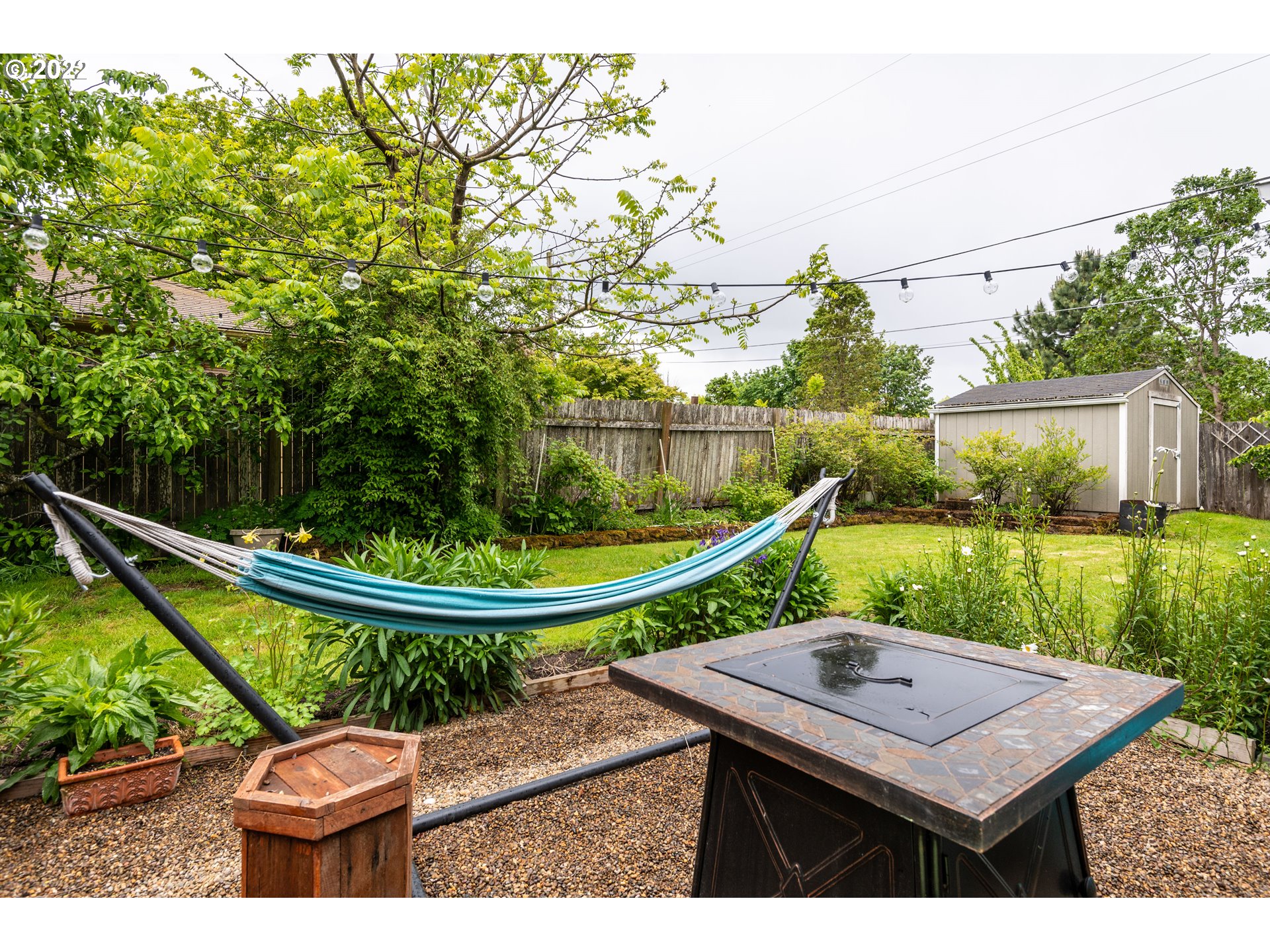 2390 Frontier Drive Eugene, OR 97401 - Photo 29 of 32 a view of a balcony with a table and chairs a barbeque with potted plants