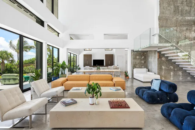 a living room with furniture fireplace and a large window