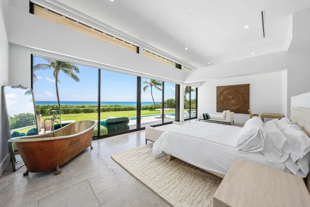 a spacious bedroom with a bed and large window