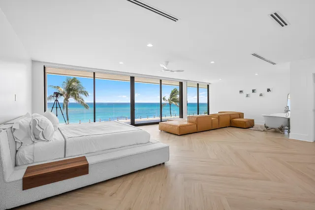 a bedroom with furniture and large windows