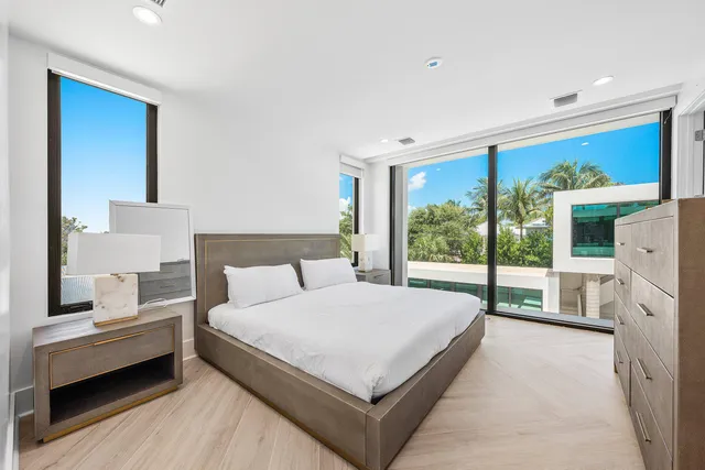 a large bedroom with a bed and large window