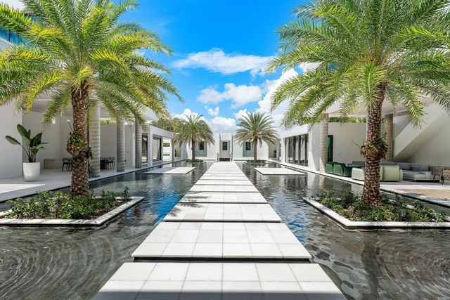 a front view of a house with lots of trees