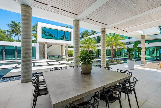 a view of an outdoor dining space with a table and chairs in patio