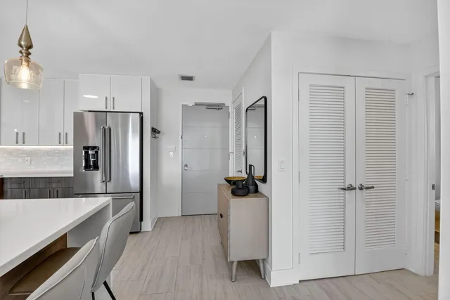 a kitchen with a refrigerator and a sink