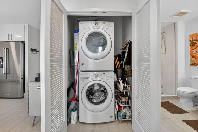 a utility room with sink dryer and washer