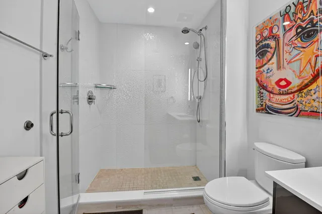 a bathroom with a toilet and a shower