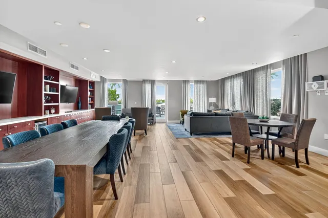 a view of a dining room with furniture and wooden floor