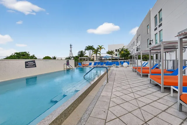 a view of a swimming pool with an outdoor seating