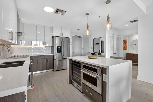 a kitchen with a stove a sink and a refrigerator