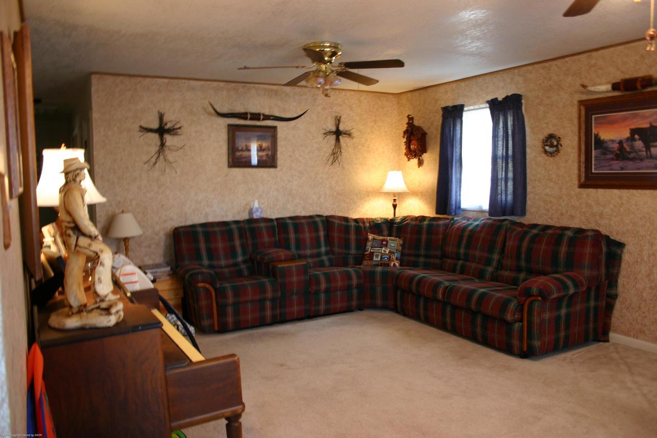 4618 South Rusk Street Amarillo, TX 79110 - Photo 2 of 10 a living room with furniture and a fireplace