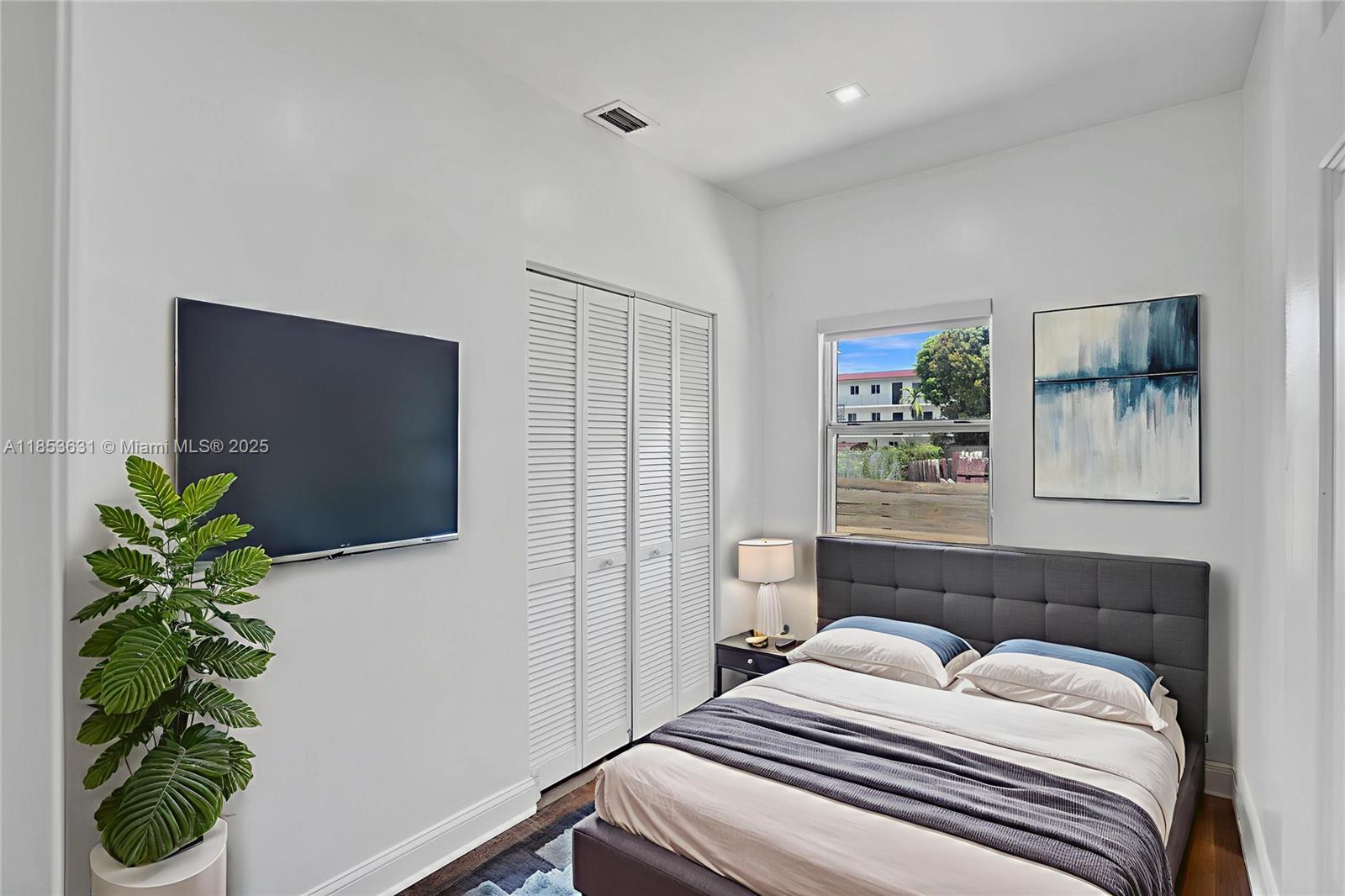 2135 Southwest 4th Street Miami, FL 33135 - Photo 15 of 28 a bedroom with a bed and a potted plant