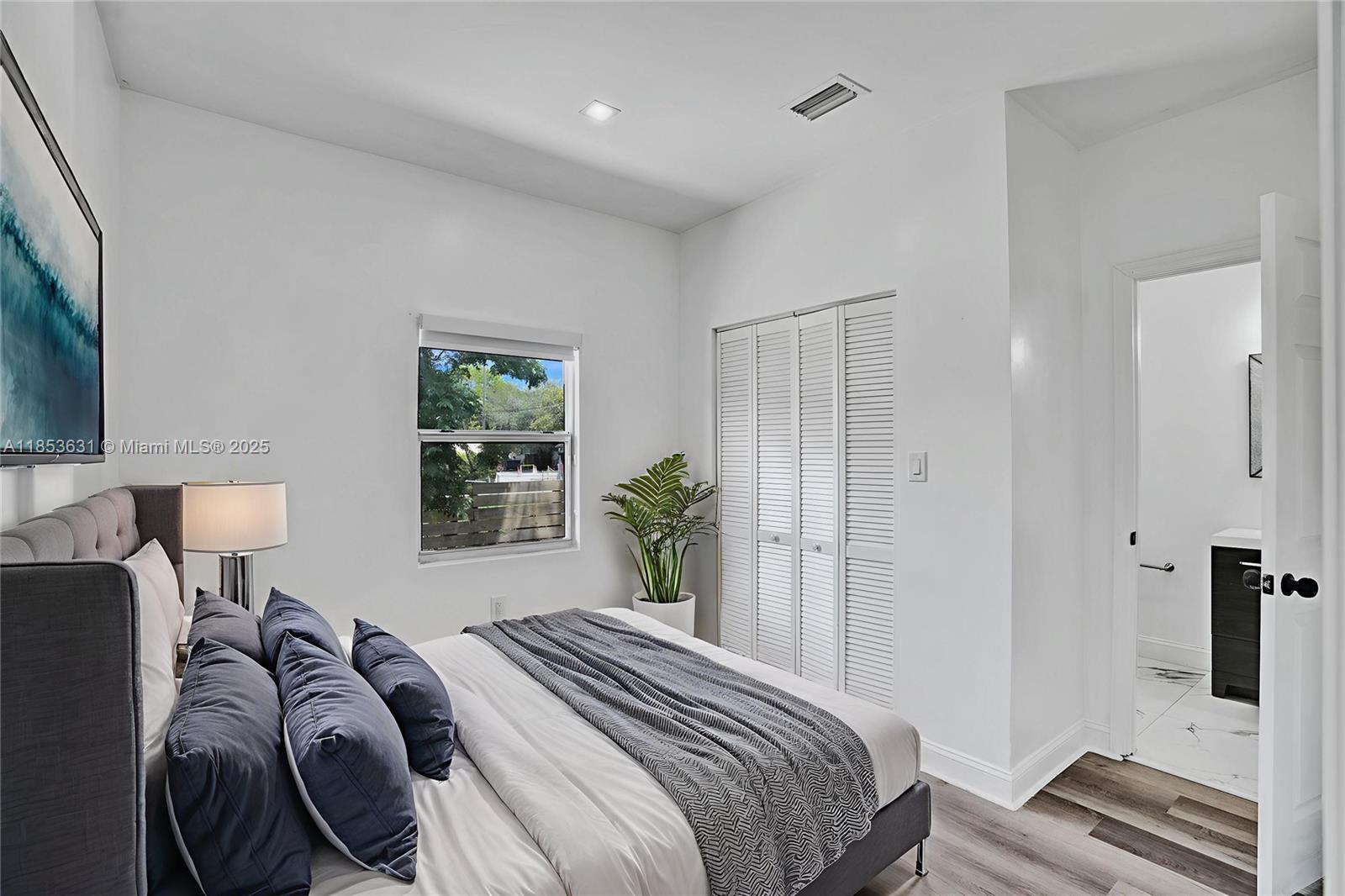 2135 Southwest 4th Street Miami, FL 33135 - Photo 4 of 28 a bedroom with a bed and a lamp