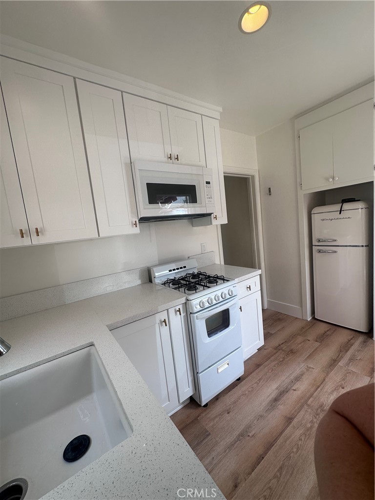243 North Grand Street, Unit 1/2 Orange, CA 92866 - Photo 12 of 29 a kitchen with white cabinets and a stainless steel appliances