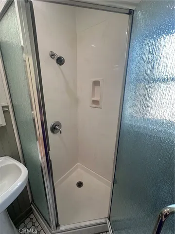 a bathroom with a toilet and a shower