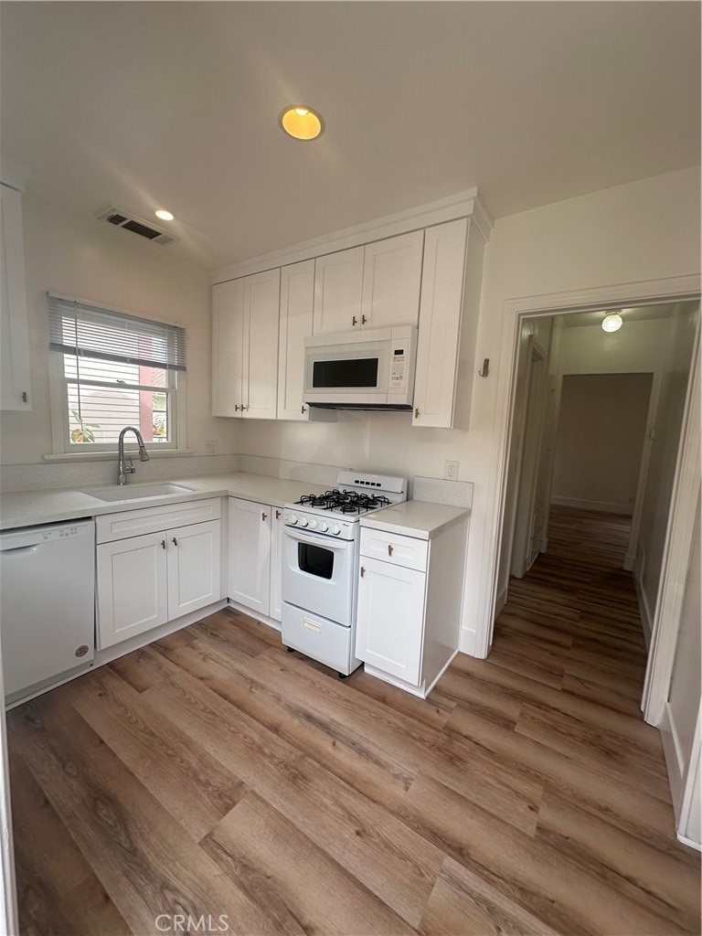 243 North Grand Street, Unit 1/2 Orange, CA 92866 - Photo 3 of 29 a kitchen with granite countertop white cabinets and white appliances