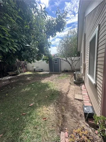 a backyard of a house with table and chairs