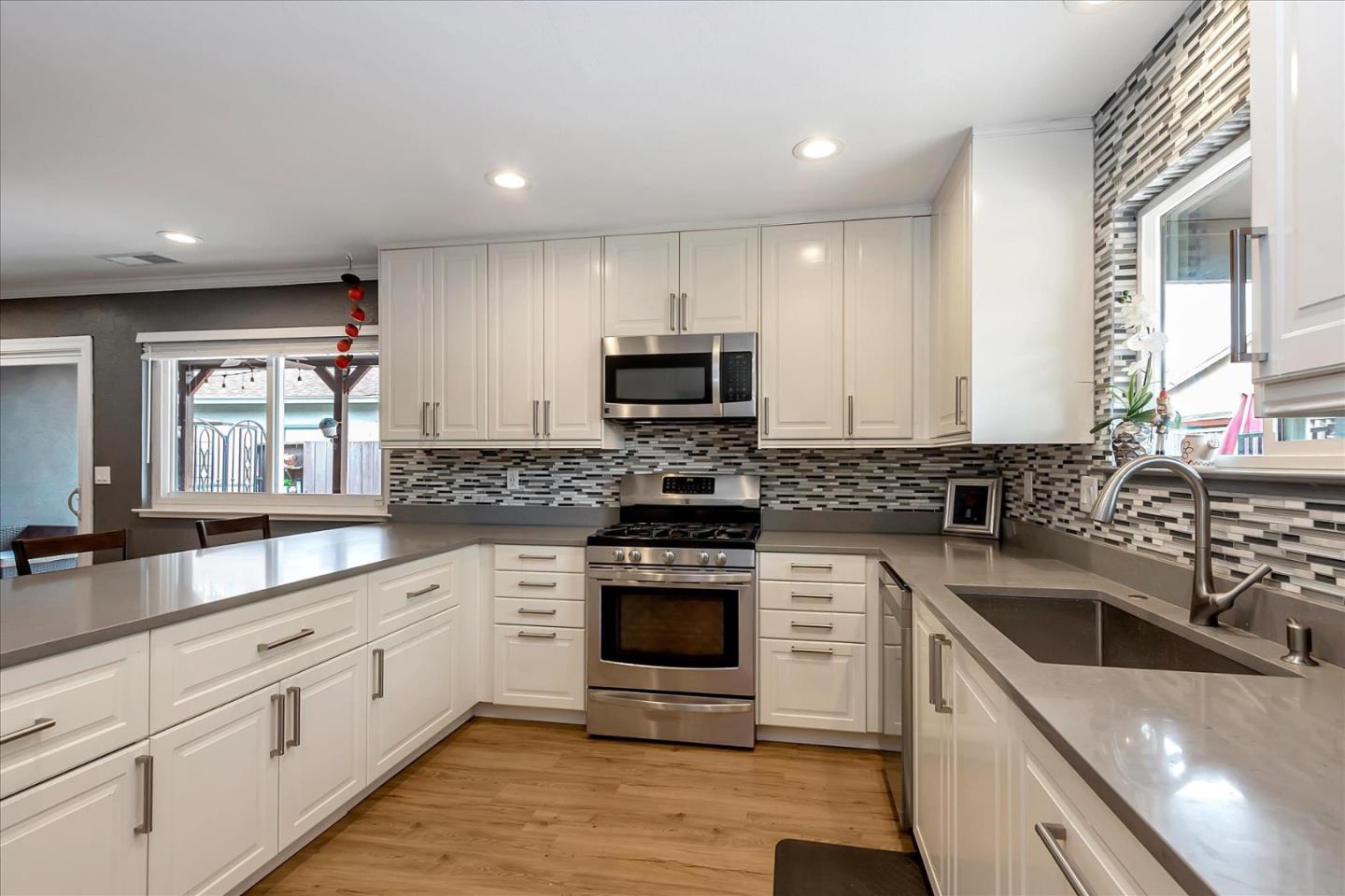 637 Escuela Place Milpitas, CA 95035 - Photo 13 of 49 a kitchen with granite countertop white cabinets white stainless steel appliances and a sink
