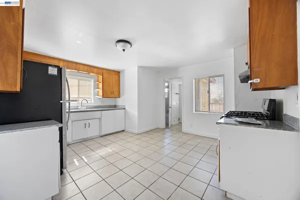 a kitchen with a sink a stove and cabinets