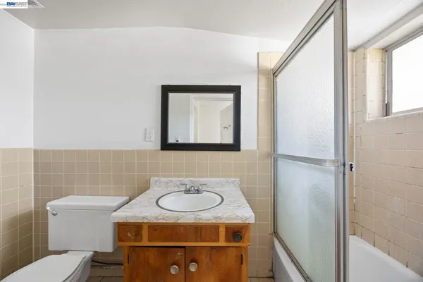 a bathroom with a sink toilet and mirror