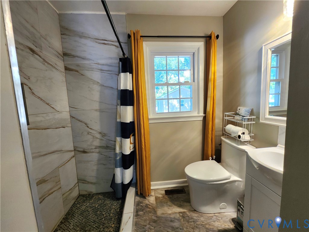 2718 Stacie Road Richmond, VA 23224 - Photo 25 of 50 Walk-in shower with large-format tile