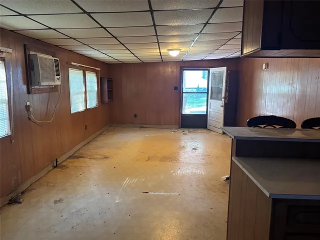 a kitchen with a stove a refrigerator and cabinets