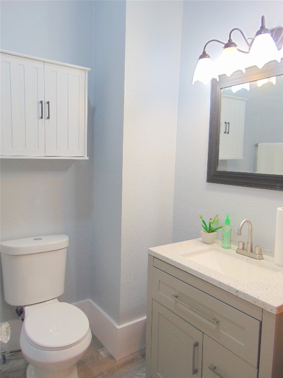 3420 Avenue R Galveston, TX 77550 - Photo 17 of 36 a bathroom with a toilet a sink and mirror