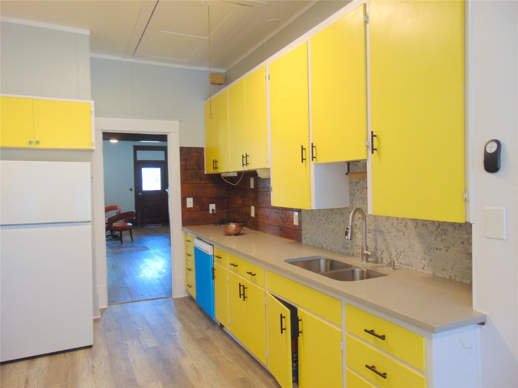 3420 Avenue R Galveston, TX 77550 - Photo 21 of 36 a kitchen with sink and refrigerator