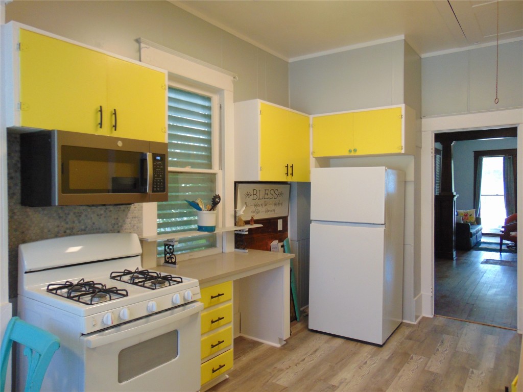 3420 Avenue R Galveston, TX 77550 - Photo 22 of 36 a kitchen with a stove and a refrigerator