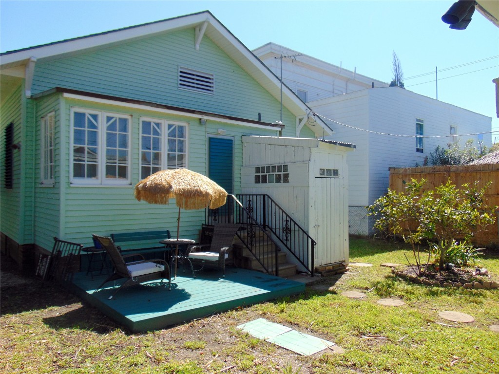3420 Avenue R Galveston, TX 77550 - Photo 32 of 36 a backyard of a house with yard and outdoor seating