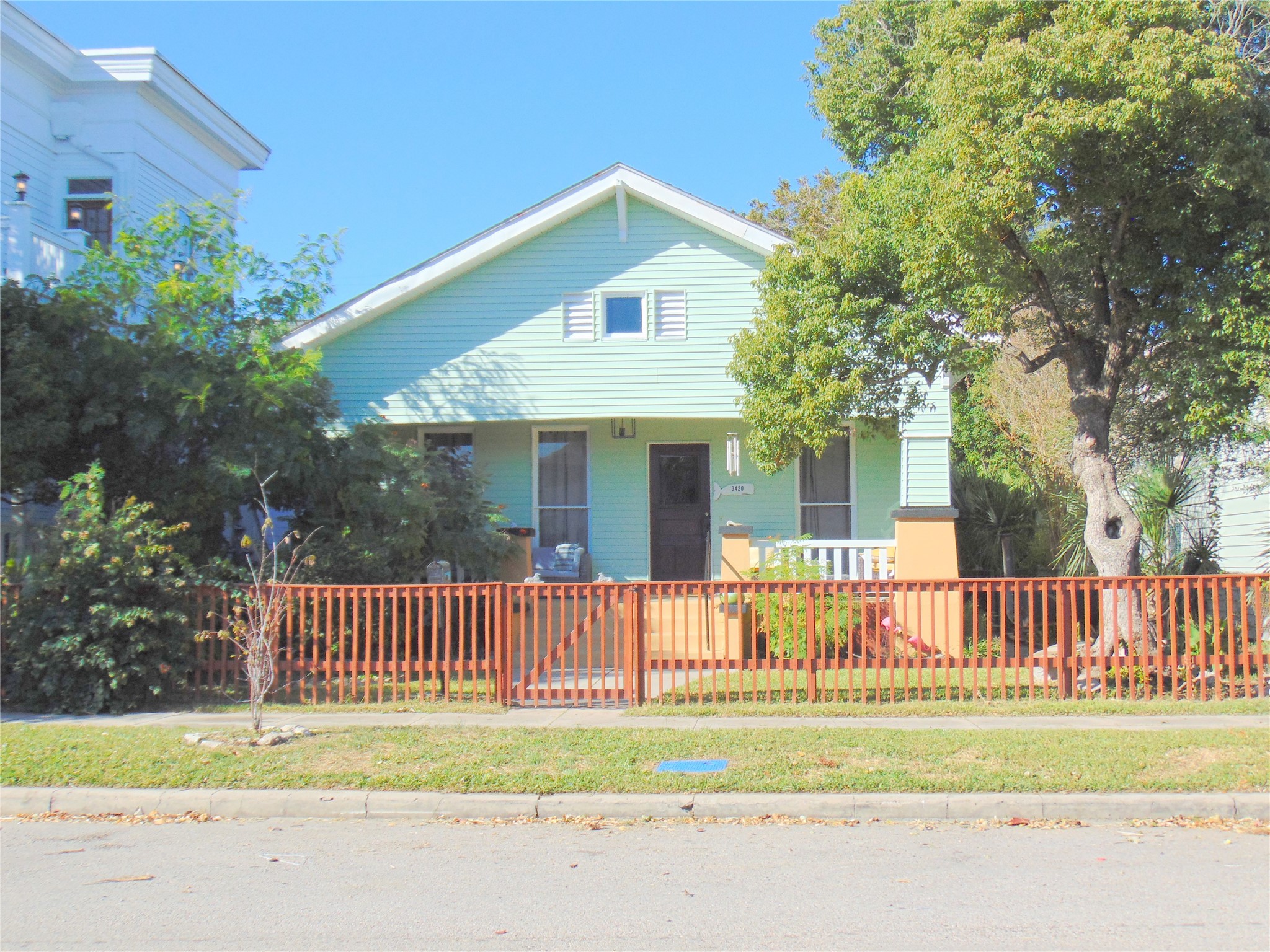3420 Avenue R Galveston, TX 77550 - Photo 33 of 36 a front view of a house with a garden and porch